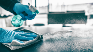 Sanitizing a desk surface in an office building in Downers Grove, Illinois